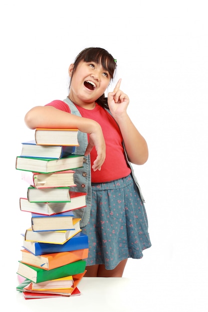 Portrait of young girl with her books and look up to copy space