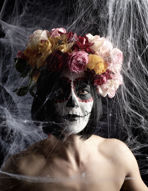 Portrait of a young girl with makeup in the image of Katrina for the holiday of the Day of the Dead.