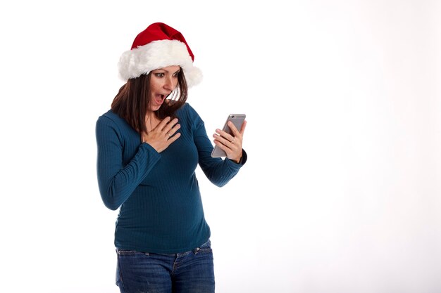 Portrait of a young girl with a Santa Claus hat on a white background