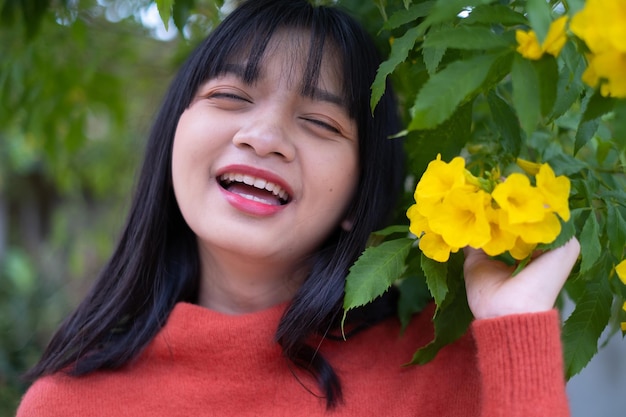 Portrait young girl with yellow flowers Asian girl