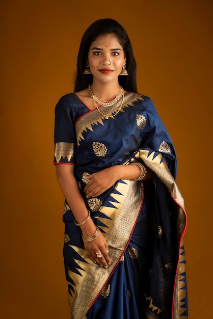 Portrait of a young girl or woman posing on brown background