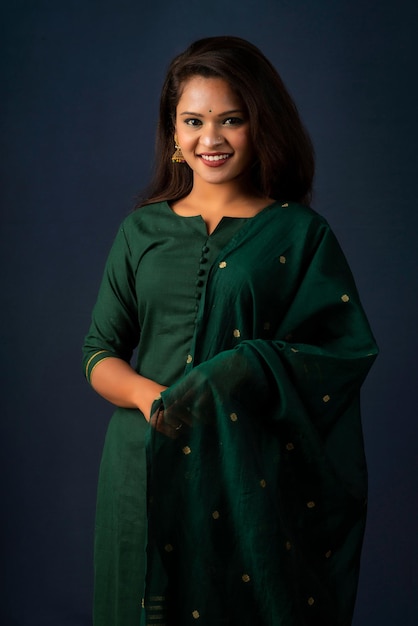 Portrait of a young girl or woman posing on gray background