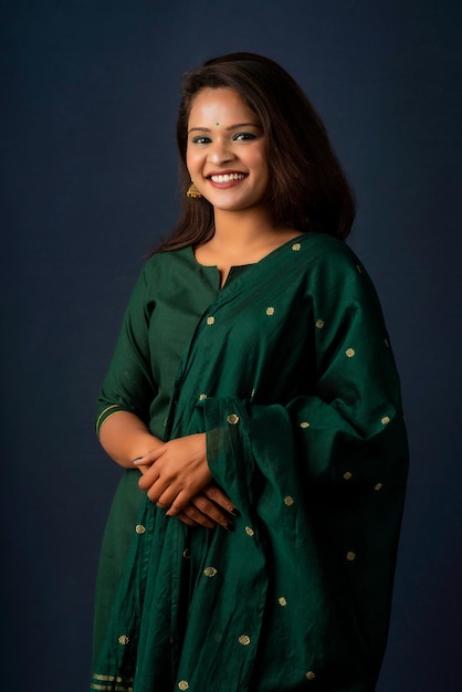 Portrait of a young girl or woman posing on gray background