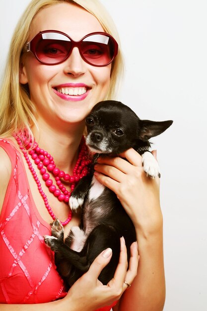 Portrait of young glamorous woman with toyterrier