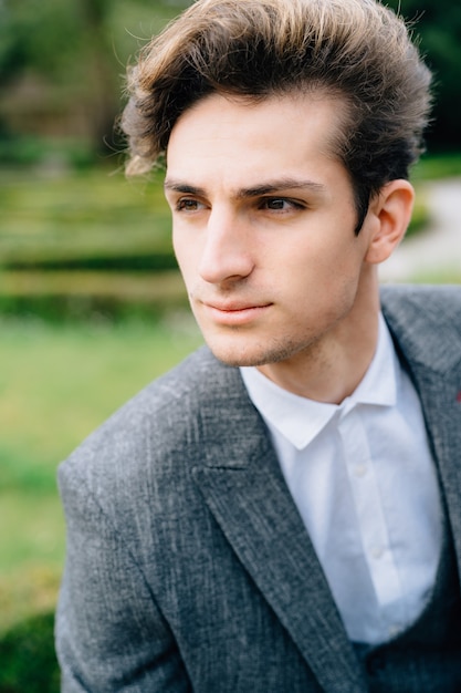 Portrait of a young groom pensively looking into the distance