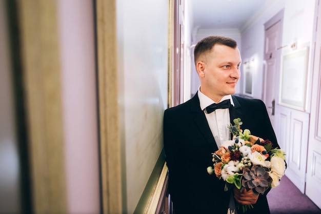 Portrait of a young groom posing