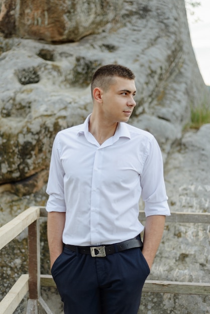 Portrait of a young groom shot in the mountains