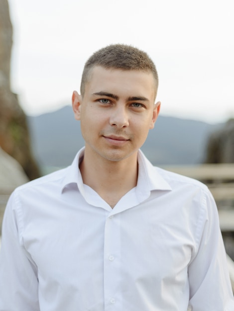 Portrait of a young groom shot in the mountains