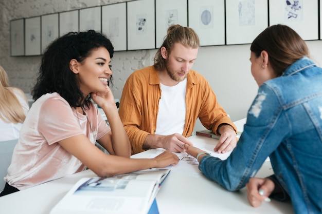 Portrait of young group of people working together in office. Group of students studying together in classroom