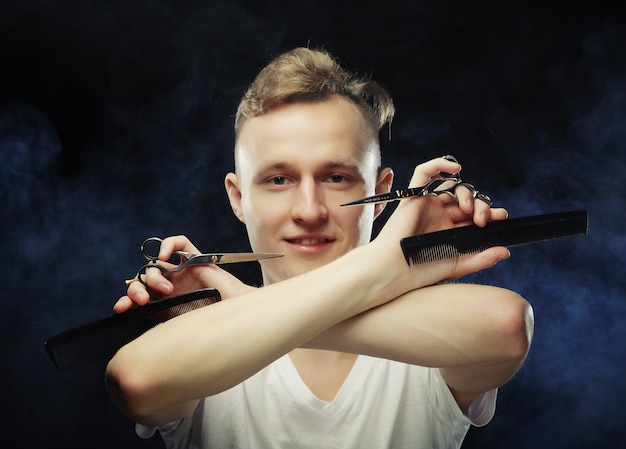 Portrait of young hairstylist looking at camera