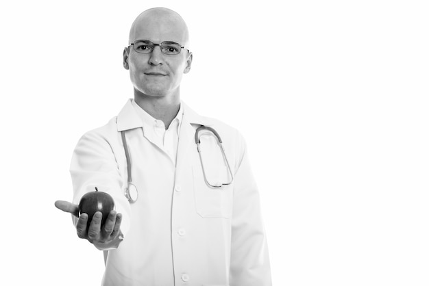 Portrait of young handsome bald man doctor isolated on white in black and white