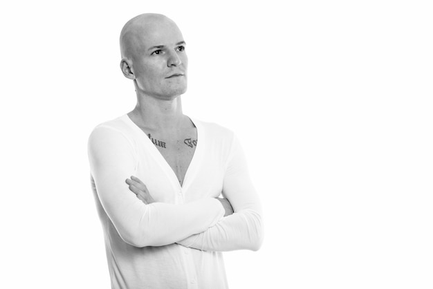 Portrait of young handsome bald man isolated on white in black and white