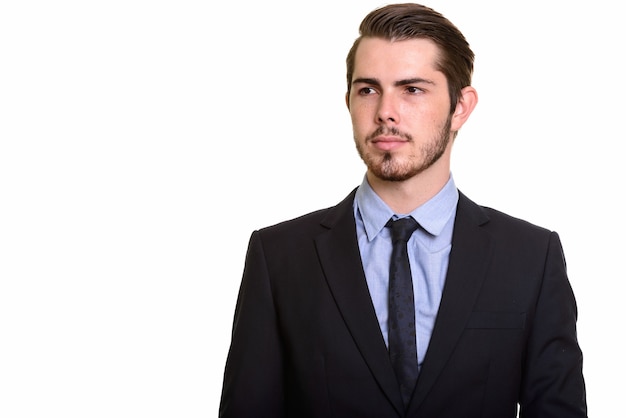 Portrait of young handsome bearded businessman in suit