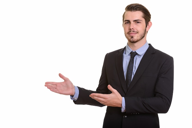 Portrait of young handsome bearded businessman in suit