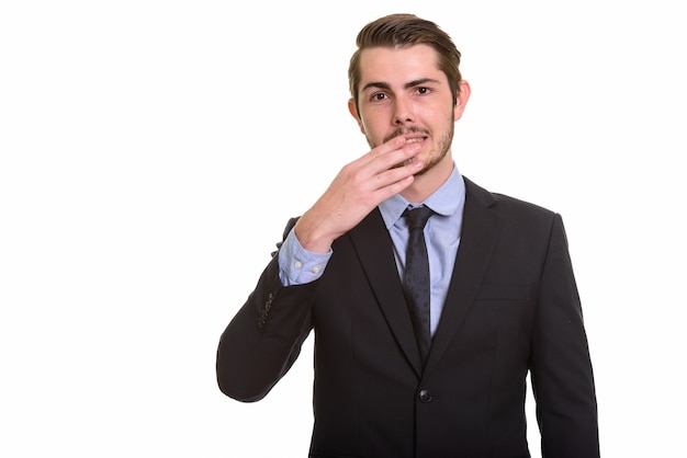 Portrait of young handsome bearded businessman in suit