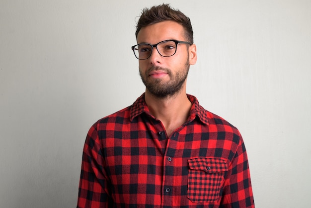 portrait of young handsome bearded hipster man on white