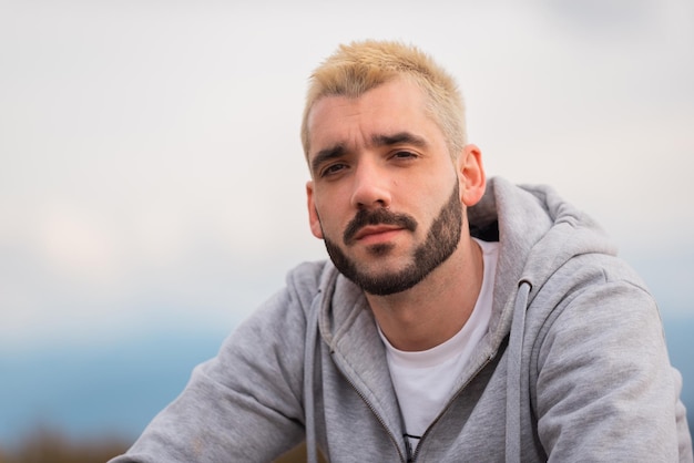 Portrait of a young handsome bearded man blonde hair