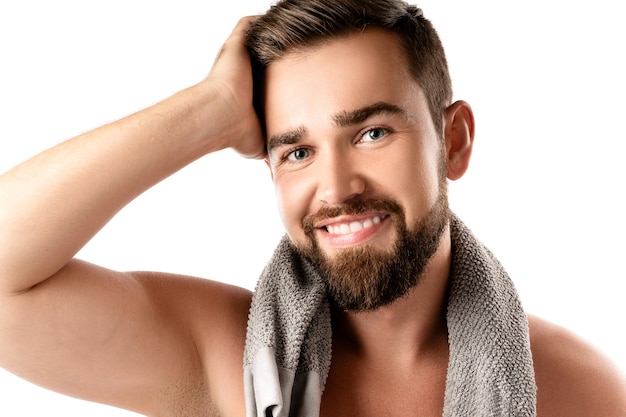 Portrait of young and handsome bearded man with smooth skin on white background