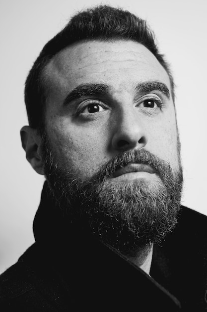 Portrait of a young handsome bearded model Black and white photo.