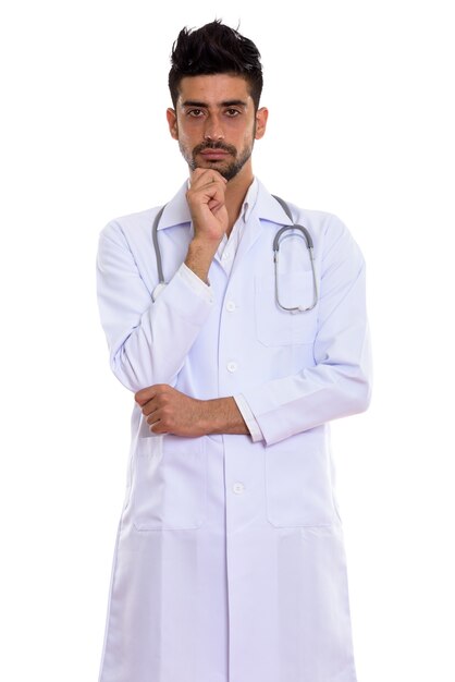 Portrait of young handsome bearded Persian man doctor