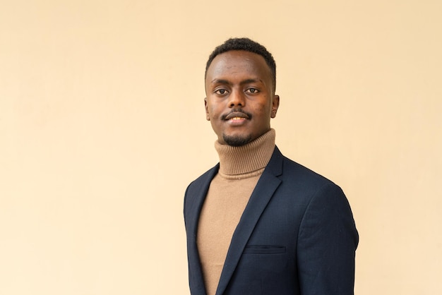 Portrait of young handsome black businessman smiling