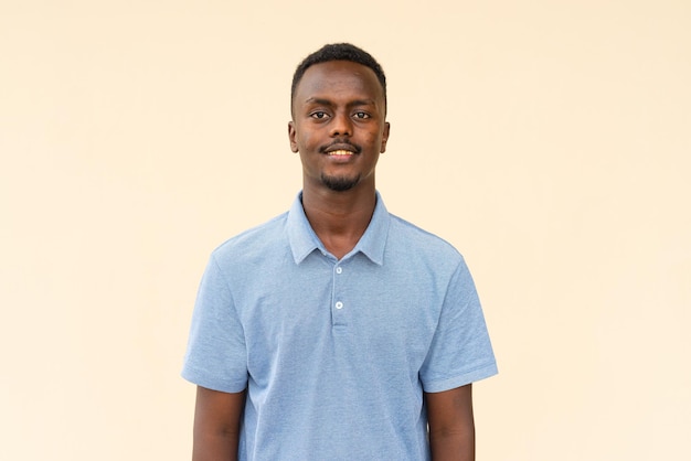 Portrait of young handsome black businessman smiling