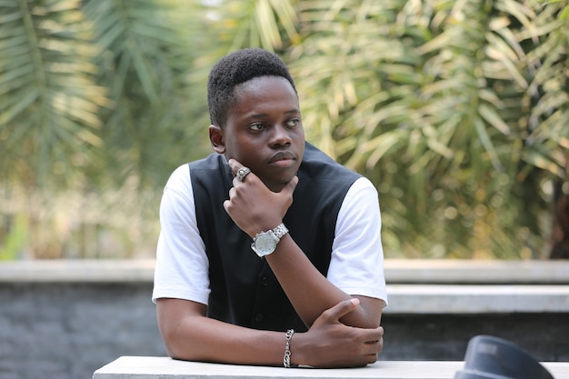 Portrait of young handsome  black man posing outdoor.