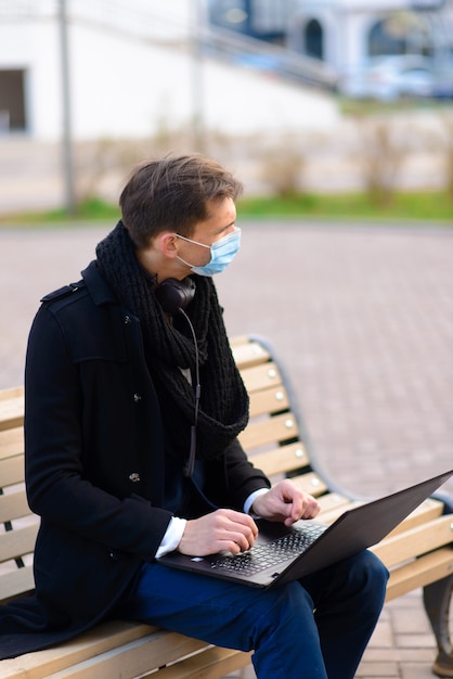 Portrait of young handsome businessman with face mask