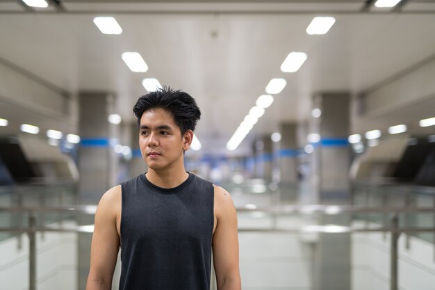 Portrait of young handsome Filipino man in the city of Bangkok, Thailand