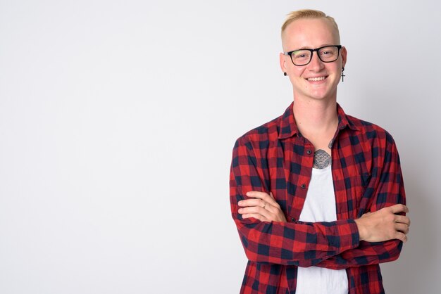 Portrait of young handsome hipster man with short blond hair wearing eyeglasses on white