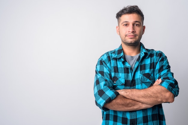 Portrait of young handsome Iranian hipster man on white