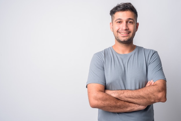 Portrait of young handsome Iranian man on white