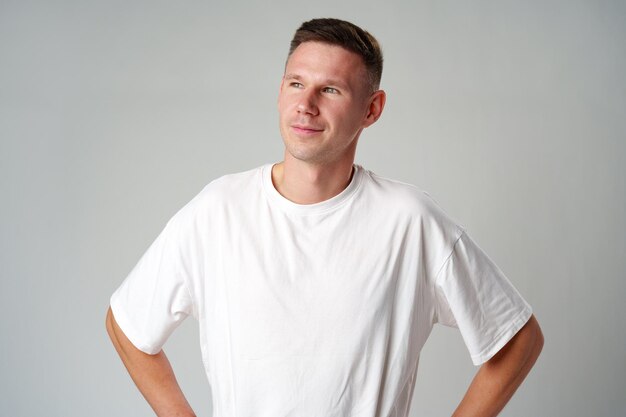 Photo portrait of a young handsome male in casual clothes on gray background