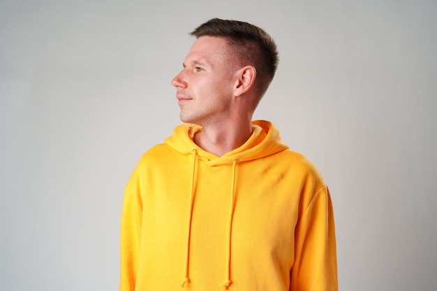 Portrait of a young handsome male in casual clothes on gray background