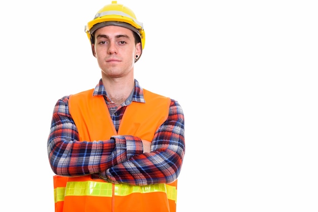 Portrait of young handsome man construction worker with arms crossed