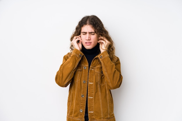 Portrait of a young handsome man covering ears