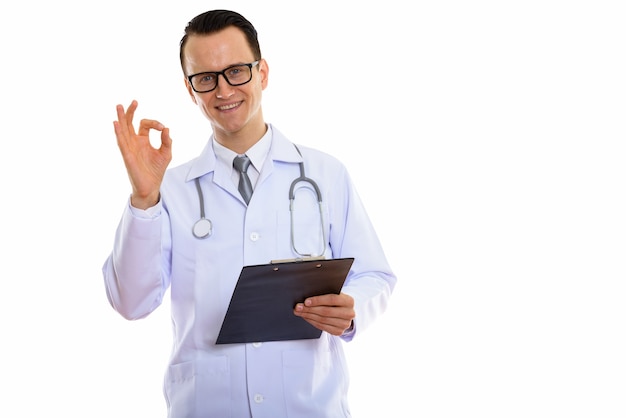 Portrait of young handsome man doctor holding clipboard