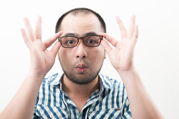 Photo portrait of young handsome man isolated on white background touching his glasses