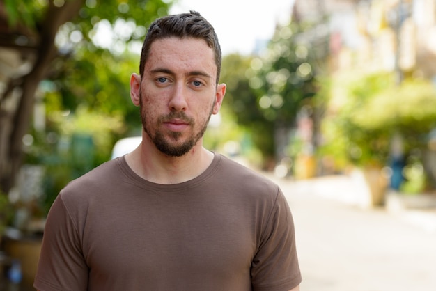 Portrait of young handsome man outdoors