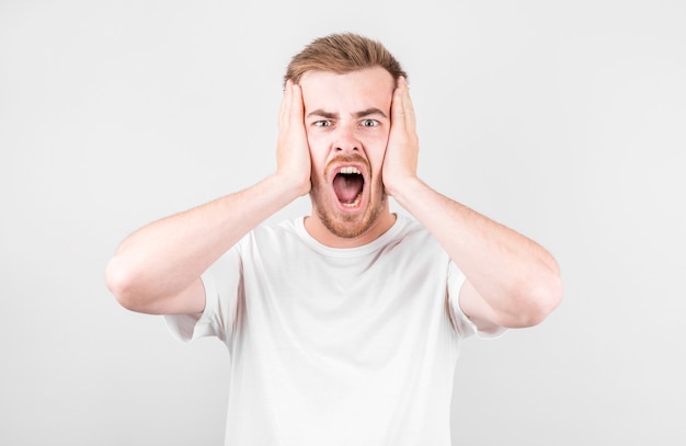 Portrait of a young handsome man screaming