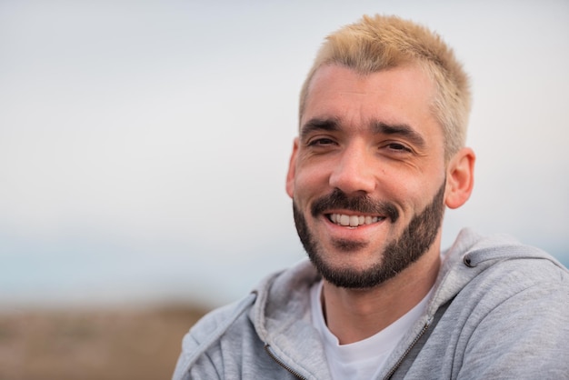 portrait of young handsome man smiling outdoor