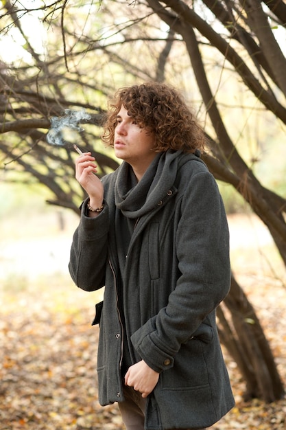 Portrait of a young handsome man smoking