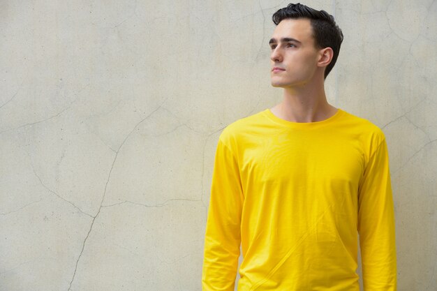 Portrait of young handsome man wearing long sleeved shirt