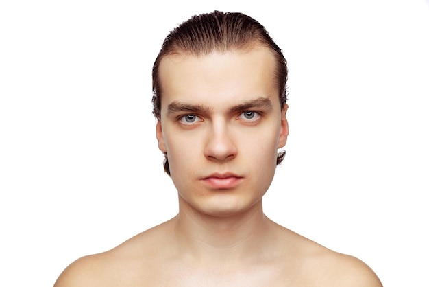 Portrait of young handsome man with perfect smooth skin posing isolated over white studio backgorund