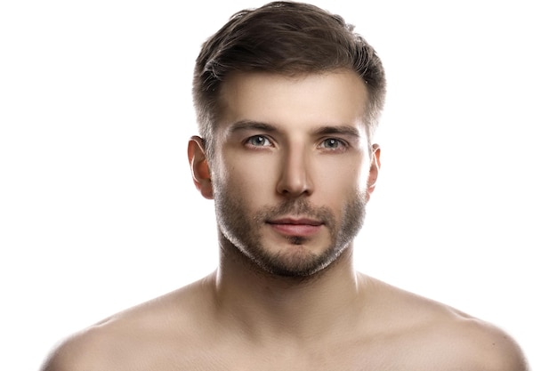 Portrait of young and handsome man with smooth skin posing on white background