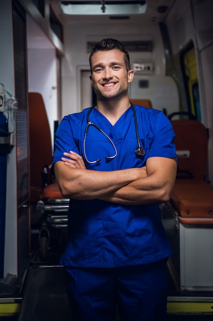 A portrait of a young handsome paramedic with a toothy smile