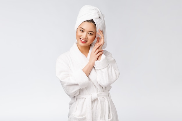 Portrait of a young happy asian lady in bathrobe.Isolated in white background.