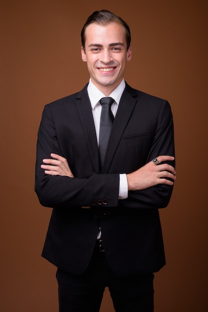 Portrait of young happy Caucasian businessman smiling