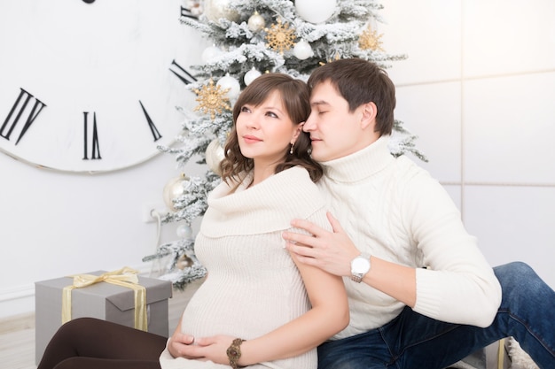 Portrait of young happy couple expecting a baby