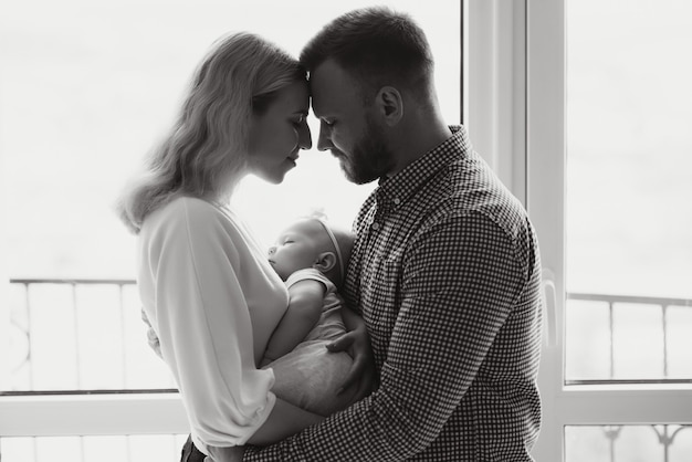 Portrait of a young happy family with the kid